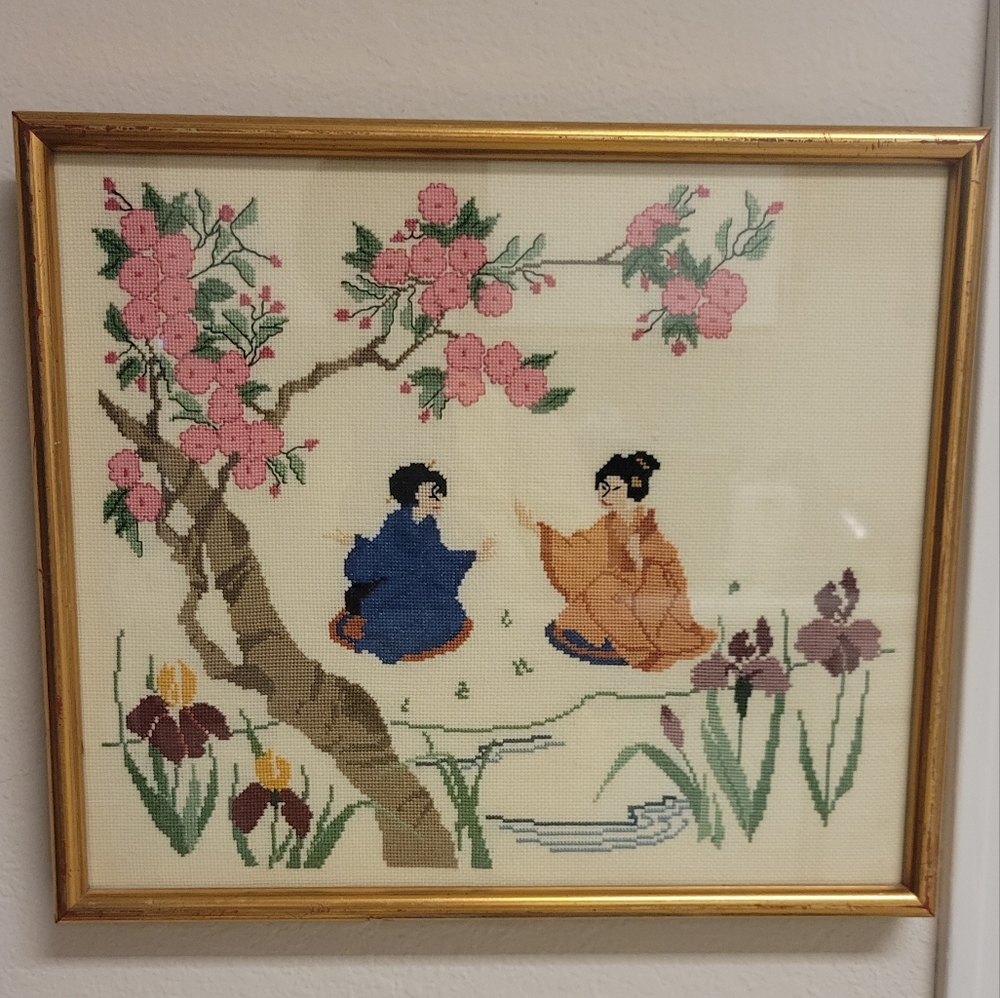 Vintage Asian cross stitch fabric in frame.
